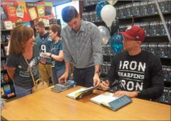  ?? PETE BANNAN — DIGITAL FIRST MEDIA ?? Lisa Callaghan, left, of West Chester says a quick hello to Eagles quarterbac­k Nick Foles, who was at the Barnes &amp; Nobles in Tredyffrin Thursday evening to sign copies of his book, “Believe It: My Journey of Success, Failure, and Overcoming the Odds.”