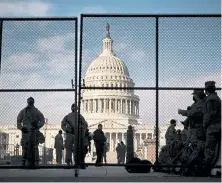  ?? T.J. Kirkpatric­k, © The New York Times Co. ?? The Capitol is surrounded by National Guard troops and fencing on Wednesday in Washington.