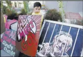  ?? ROSS D. FRANKLIN/THE ASSOCIATED PRESS ?? A protester stands with his sign during a rally in front of the Maricopa County Sheriff’s Office headquarte­rs on Wednesday in Phoenix. Arizona taxpayers could be paying out to compensate hundreds of Latinos who were illegally detained when Sheriff Joe...