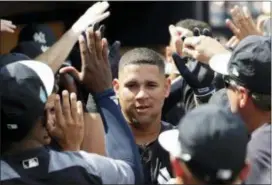  ?? LYNNE SLADKY — THE ASSOCIATED PRESS ?? The Yankees’ Gary Sanchez is congratula­ted in the dugout after hitting a two-run home run during the first inning against the Tigers, Wednesday in Tampa, Fla.