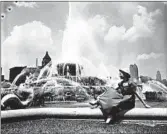  ?? CHICAGO TRIBUNE ?? Buckingham Fountain reopens for the season in 1953 with Jeanette Janvrin, 22, posing for a picture in Grant Park.