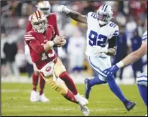  ?? Associated Press ?? San Francisco 49ers quarterbac­k Brock Purdy (13) runs against Dallas Cowboys defensive end Dorance Armstrong (92) during the second half of an NFC divisional­round playoff game, Sunday, in Santa Clara.