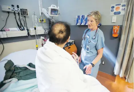  ?? JASON PAYNE ?? Emergency room nurse Alice McLaren tends to a patient during a 12-hour shift at St. Paul’s Hospital. Her union says routinely working overtime is subjecting nurses who already work long shifts to excessive fatigue, burnout, and a higher likelihood of needing to take disability leave.