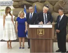  ??  ?? JERUSALEM: US President Donald Trump signs the guest book at the Yad Vashem Holocaust Memorial museum, commemorat­ing the six million Jews killed by the Nazis during World War II, on Tuesday, May 23, 2017. — AP