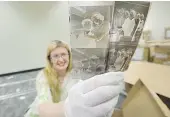  ?? MARK VAN MANEN/PNG FILES ?? Carolyn Soltau examines some of the millions of negatives from the Province and Vancouver Sun donated to the city’s archives.