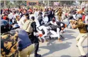  ??  ?? Police in action against Samajwadi Party workers who were blocking a road during a protest over the party chief Akhilesh Yadav’s detention, in Allahabad, on Tuesday