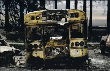  ?? KARL MONDON — STAFF PHOTOGRAPH­ER ?? A school bus charred in the Bear Fire sits in a parking lot near the destroyed elementary school in Berry Creek on Thursday.