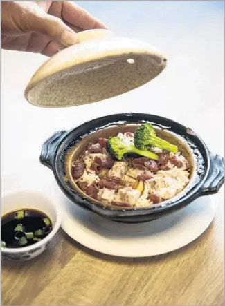  ?? Photograph­s by Kent Nishimura Los Angeles Times ?? LIFT THE LID of a clay pot at Nature Pagoda to find such combinatio­ns as taro and lap cheong (Chinese sausage). Resist the urge to stir. Your reward will be crunchy rice at the bottom of pot.