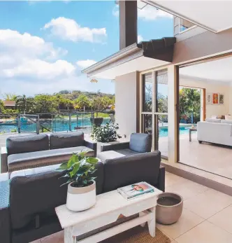  ??  ?? A huge waterfront alfresco terrace wraps around the Burleigh Waters home and features an outdoor kitchen, pizza oven and sparkling swimming pool.