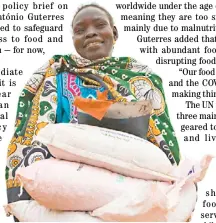  ?? PHOTOGRAPH COURTESY OF UN ?? A WOMAN carries sacks of seeds distribute­d to families in South Sudan during the COVID-19 pandemic.