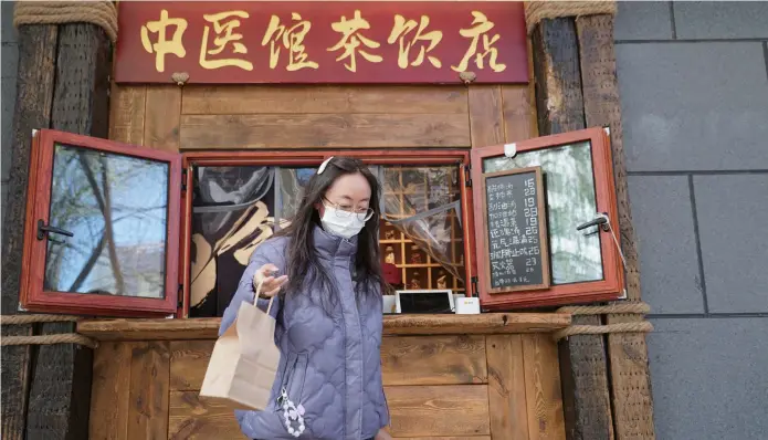  ?? ?? A shopper takes her tea drink from a yangsheng-themed beverage shop in Xining, capital of west China’s Qinghai Province. With the rising focus among young individual­s on yangsheng, which emphasizes health enhancemen­t, businesses are introducin­g health-conscious products to cater to this growing demand. — IC