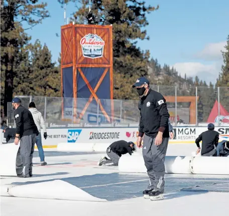  ?? Christian Petersen, Getty Images ?? NHL workers cover the ice following the first period between the Vegas Golden Knights and the Colorado Avalanche during the NHL Outdoors at Lake Tahoe game at the Edgewood Tahoe Resort on Saturday in Stateline, Nevada.