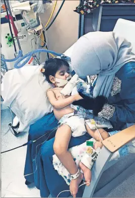  ?? [COUNCIL ON AMERICAN-ISLAMIC RELATIONS, SACRAMENTO VALLEY] ?? Shaima Swileh holds her dying 2-year-old son, Abdullah, at a hospital in Oakland, Calif., after arriving in the United States on Wednesday night.