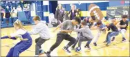  ?? Westside Eagle Observer/MIKE ECKELS ?? The eighth-grade class at Decatur Middle School tries to pull the sophomore class (out of the frame) across the center line in a tug-of-war contest during the 2019 homecoming pep rally at Peterson Gym on Friday afternoon.