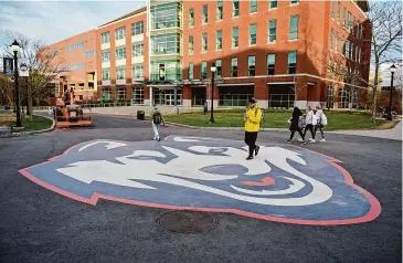  ?? Tyler Sizemore/Hearst Connecticu­t Media file photo ?? Students walk to class at the UConn campus in Storrs on April 4, 2022.