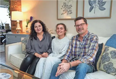  ?? ENQUIRER PHIL DIDION/THE ?? From left:colleen, Maure and David Thompsons sit for a portrait in their home. Colleen and David Thompson adopted Maure from Ukraine last summer. Maure is one of six children from Ukraine the Thompsons have adopted.