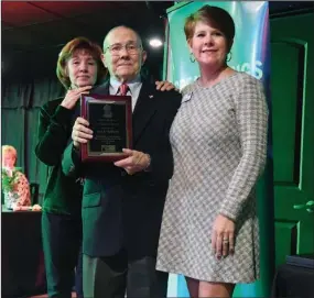  ?? The Sentinel-Record/Grace Brown ?? EXEMPLARY SERVICE: Paul Nothern, center, accepts the Terry Wallace Volunteer Award from Sarah Fowler, right, executive director of United Way of the Ouachitas, during the organizati­on’s annual meeting Thursday at the Hot Springs Event Center. Nothern was joined by his wife, Willie.