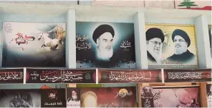  ?? (Issam Abdallah/Reuters) ?? BANNERS DEPICTING Iran’s late leader Ayatollah Ruhollah Khomeini, Supreme Leader Ayatollah Ali Khamenei and Lebanese Hezbollah leader Hassan Nasrallah are posted in Yaroun in southern Lebanon on Monday.