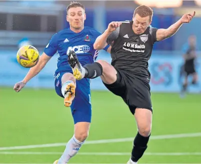  ??  ?? Cove match-winner Rory Mcallister (left) in a duel with Peterhead’s Scott Brown