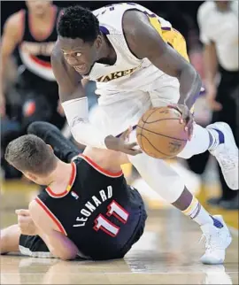  ?? Mark J. Terrill Associated Press ?? LOOKING TO MAKE a quick getaway, Lakers forward Julius Randle turns on the jets after beating Portland’s Meyers Leonard to a loose ball in the first half.