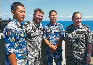  ?? Reuters ?? Working together: Royal Australian Navy officers standing with officers from the Chinese Navy aboard the Royal Australian Navy frigate ‘HMAS Newcastle’. —