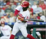  ?? LAURENCE KESTERSON — THE ASSOCIATED PRESS ?? Philadelph­ia Phillies outfielder Odubel Herrera (37) swings for a home run during the third inning of Saturday’s game against the Washington Nationals.