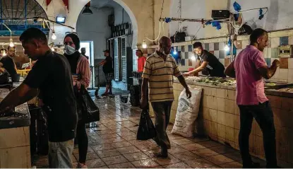  ?? Ivor Prickett / New York Times ?? Shoppers visit a fish market in Tunis, Tunisia. Pressure is mounting on Tunisian President Kais Saied to salvage the economy. Deeply indebted after years of mismanagem­ent and the pandemic, Tunisia is seeking to borrow nearly $7 billion.