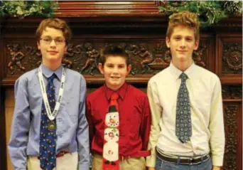  ??  ?? Devon Prep seventh-grader Ian McKnight of Wayne, left, recently won the school’s annual Geography Bee, conducted by geography teacher George Beothy. Seventh-grader Ryan McCabe of Media, center, took second place and eighth-grader Luca Miraldi of West...