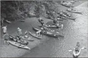  ?? Photo contribute­d by Joe Cook ?? Paddlers launch their boats at Gober Beach on Monday morning near Canton on the Etowah River during Paddle Georgia 2017.