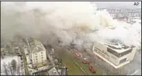  ?? AP ?? Smoke pours from mall in Kemerovo, Siberia, where 37 died and 69 were missing, 40 of them kids.