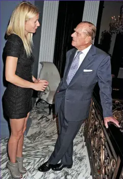  ??  ?? Head over heels: Impossibly high stilettos let Gwyneth Paltrow tower above a very relaxed Philip in 2011