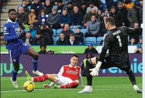  ?? ?? Priceless: Martinelli beats Wilfred Ndidi to Trossard’s nifty pass and hits a right foot shot from a narrow angle as he falls to the ground. All eyes are on the ball as the Br