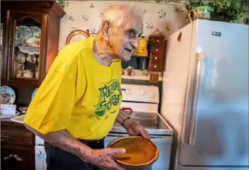  ?? Michael M. Santiago/Post-Gazette ?? Retired dairy farmer, Mike Krajacic, 91, of Avella holds a pumpkin pie he made recently using a refrigerat­ed crust because he had a hankering for it. He also makes a good pot of chicken noodle soup and sauerkraut and kielbasa, says his daughter, Cindy Fraer.