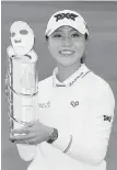  ??  ?? New Zealand’s Lydia Ko poses with her trophy after winning at Lake Merced Golf Club in Daly City, California.