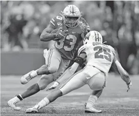  ?? [ADAM CAIRNS/DISPATCH] ?? Master Teague III, trying to elude Wisconsin safety Eric Burrell last October, rushed for 789 yards and four touchdowns as the backup to J.K. Dobbins.