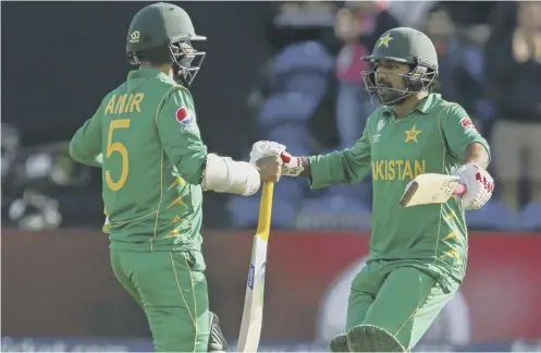  ??  ?? Pakistan’s Mohammad Amir, left, celebrates with Sarfraz Ahmed after their side’s three-wicket victory against Sri Lanka in Cardiff.