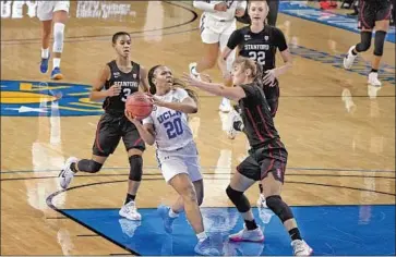  ?? Marcio Jose Sanchez Associated Press ?? UCLA’S
Charisma Osborne, driving to the basket against Stanford, is averaging 18.1 points and 4.5 assists.