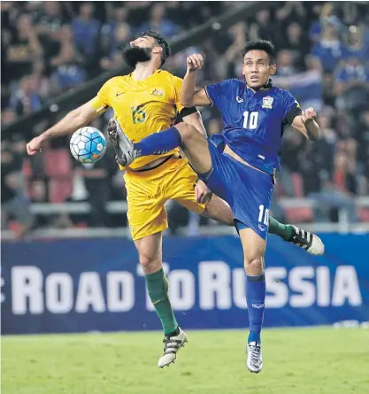 ??  ?? Thailand’s Teerasil Dangda, right, in action against Australia in a World Cup qualifier.