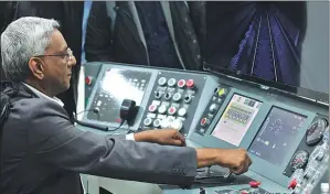  ?? LI JIN / CHINA DAILY ?? A visitor learns to operate a high-speed railway system in Liuzhou.