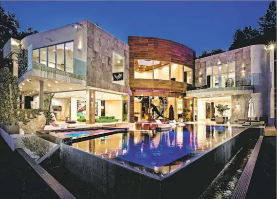  ?? Photograph­s by Juwan Li ?? THIS MODERN canyon-view residence in Bel-Air features a computeriz­ed waterfall feature that feeds a lavish swimming pool.