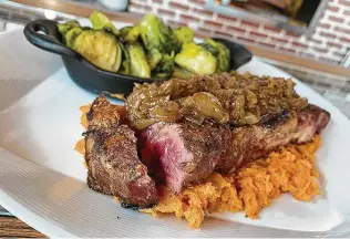  ??  ?? New York strip steak, with Brussels sprouts and mashed sweet potatoes, is served at the new Richter Tavern.