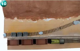  ??  ?? With the worst of the messy work complete, the track is put back into position. I double check that there is clearance on the lower level and that the hoppers on the narrow gauge are close enough to the edge to tip their load into the standard gauge wagons.