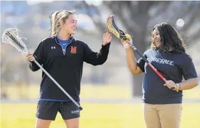  ?? LLOYD FOX/BALTIMORE SUN PHOTOS ?? Sophomore Tamiera Brown, right, wanted to be a team manager before coach Zoe Stukenberg started teaching her stick tricks. Brown says: “Seeing her at practice makes us want to be like her. When she does her tricks, I’m like ‘I’m going to learn how to...