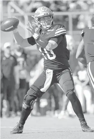  ?? PHELAN M. EBENHACK/AP ?? Team Aina quarterbac­k McKenzie Milton, of Florida State, throws a pass during the first half of the Hula Bowl on Saturday in Orlando.