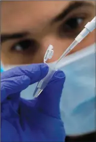  ?? ?? Research assistant Robert demonstrat­es how to prepare a sample for sequencing.