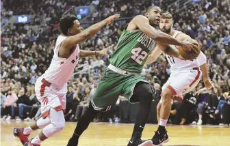  ?? AP PHOTO ?? FINDING HIS LANE: Celtics forward Al Horford gets fouled by Raptors guard Kyle Lowry (left) as the big man drives to the bucket last night in Toronto.