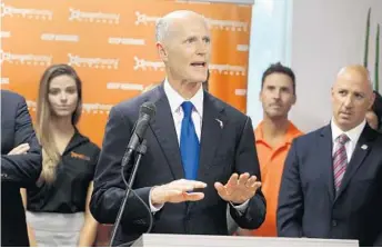  ?? CARLINE JEAN/STAFF PHOTOGRAPH­ER ?? Florida Gov. Rick Scott visits Orangetheo­ry, a fitness center franchise that moved its headquarte­rs to Boca Raton.