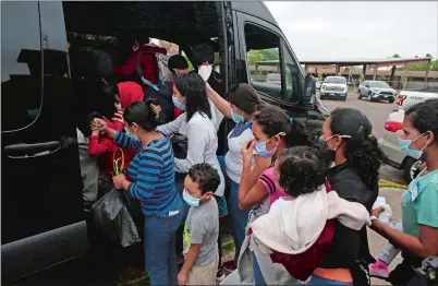  ?? DARIO LOPEZ-MILLS AP PHOTO ?? Migrants board a van at Our Lady of Guadalupe Catholic Church in McAllen, Texas, on Palm Sunday. U.S. authoritie­s are releasing migrant families at the border without notices to appear in immigratio­n court and sometimes, without any paperwork at all.