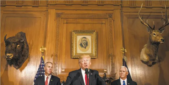  ?? Stephen Crowley / New York Times ?? President Trump, flanked by Interior Secretary Ryan Zinke (left) and Vice President Mike Pence, speaks at the signing of the executive order.