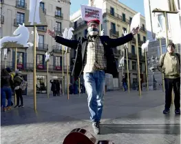  ?? — AFP ?? A man poses with his mouth covered to demand the release of political prisoners ahead of the upcoming Catalan regional election at Sant Jaume square in Barcelona on December 19, 2017. Catalan voters will decide on December 21 whether to return the...